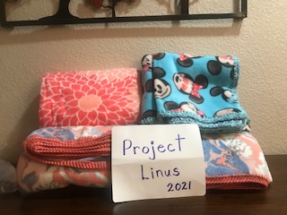 Stack of fleece blankets donated to Project Linus by The 100 Club.